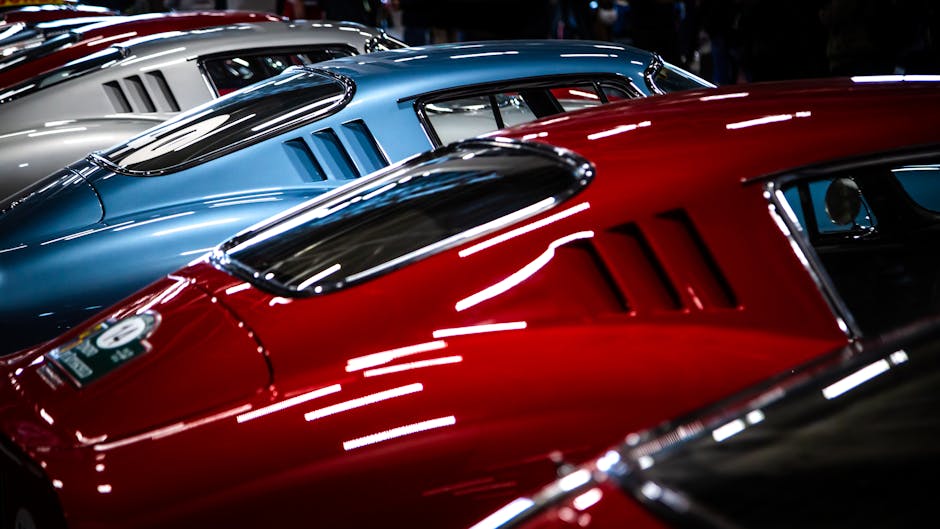 A striking lineup of vintage cars showcasing sleek design and vibrant colors.